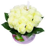 A bouquet of white roses in a round box