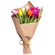 Bouquet of colorful tulips in the newspaper
