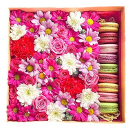 Flowers with pastries in a box