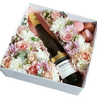 Flowers, wine and macarons in a box