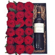 Red roses and wine in a box