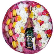 Round box with flowers, macarons and champagne