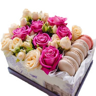 A small box with macarons and roses