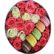 Roses and macarons in a round box
