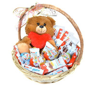 Kinder sweets and teddy bear in the basket