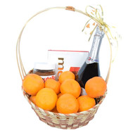 Basket with sweets, tangerines and champagne