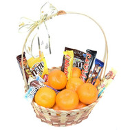 Basket with tangerines and chocolate bars