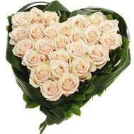 Heart-shaped composition of cream roses