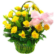 Basket of yellow roses with greens