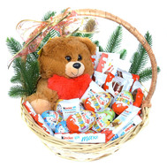 Kinder sweets and Teddy bear in the basket for the New Year