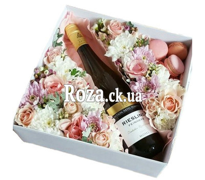 Flowers, wine and macarons in a box