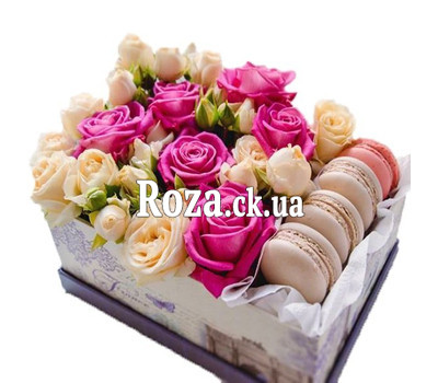 A small box with macarons and roses