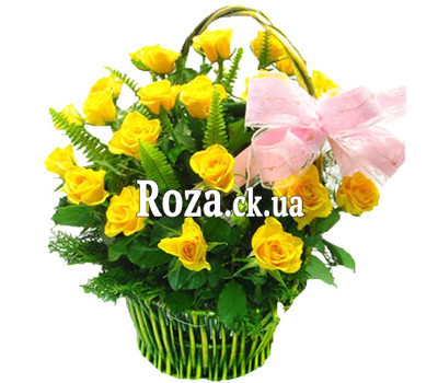 Basket of yellow roses with greens