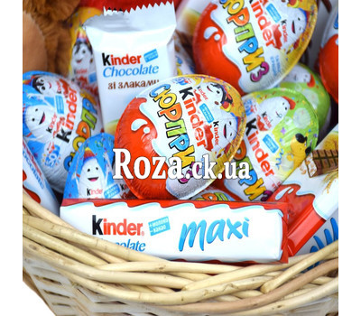 Kinder sweets and Teddy bear in the basket for the New Year 2