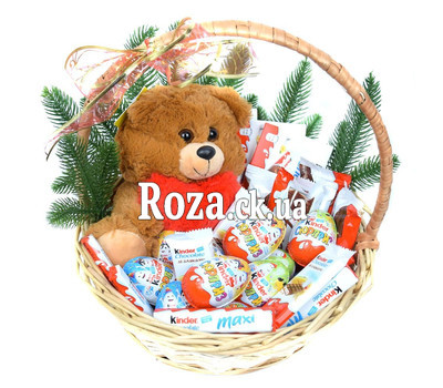 Kinder sweets and Teddy bear in the basket for the New Year